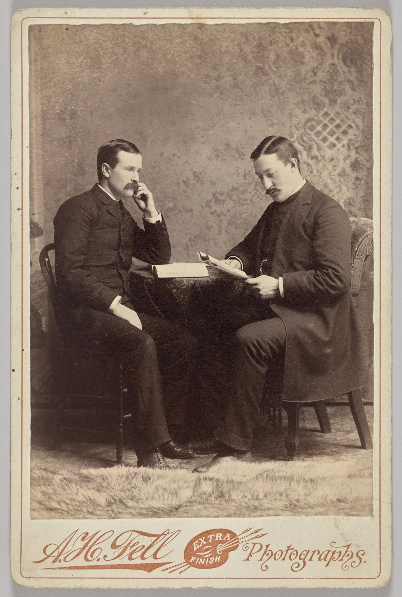 Untitled (seated portrait of two men, one with a book, the other reading a magazine), detail