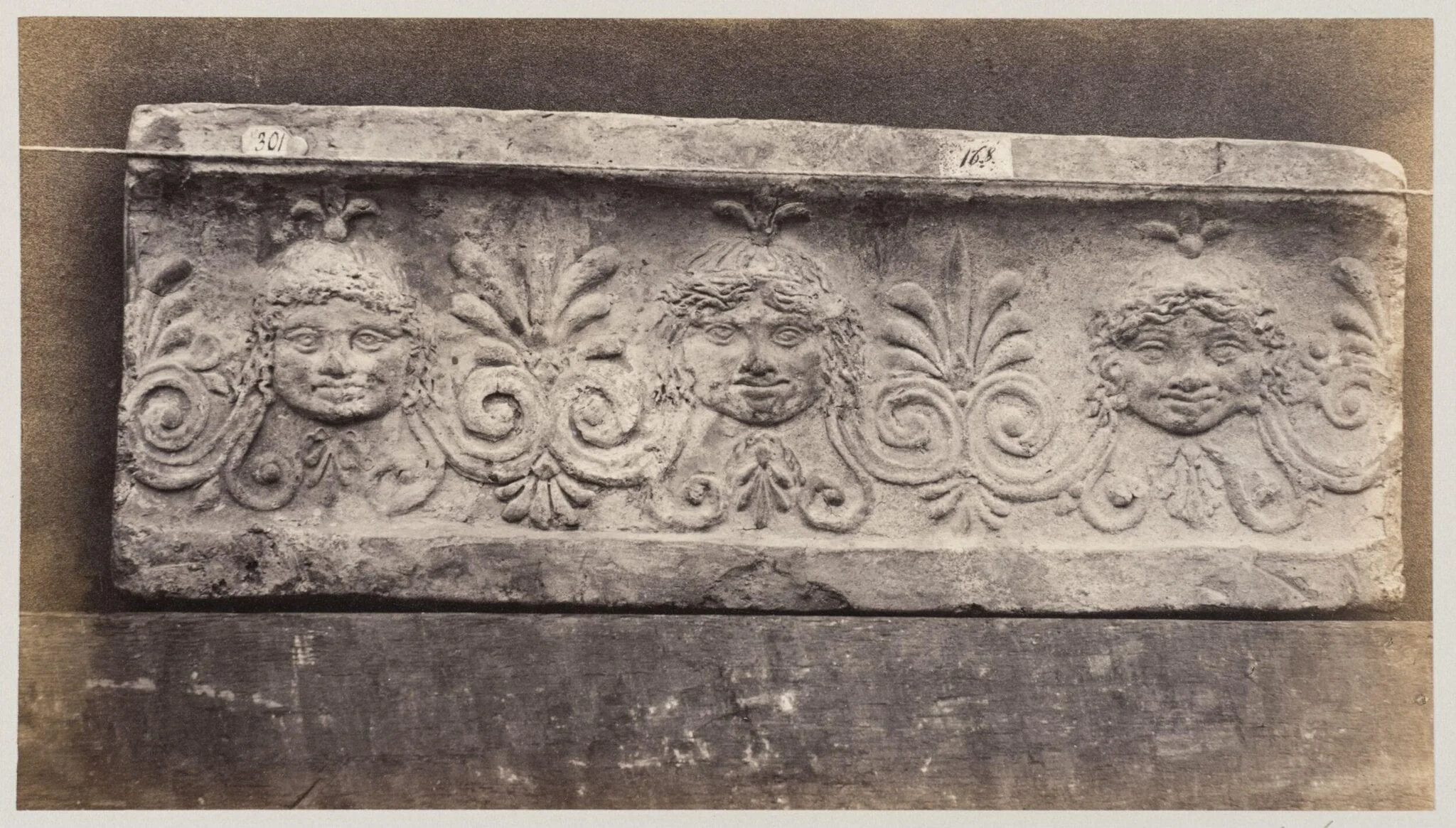 Three masques of gorgons in terra cotta, detail