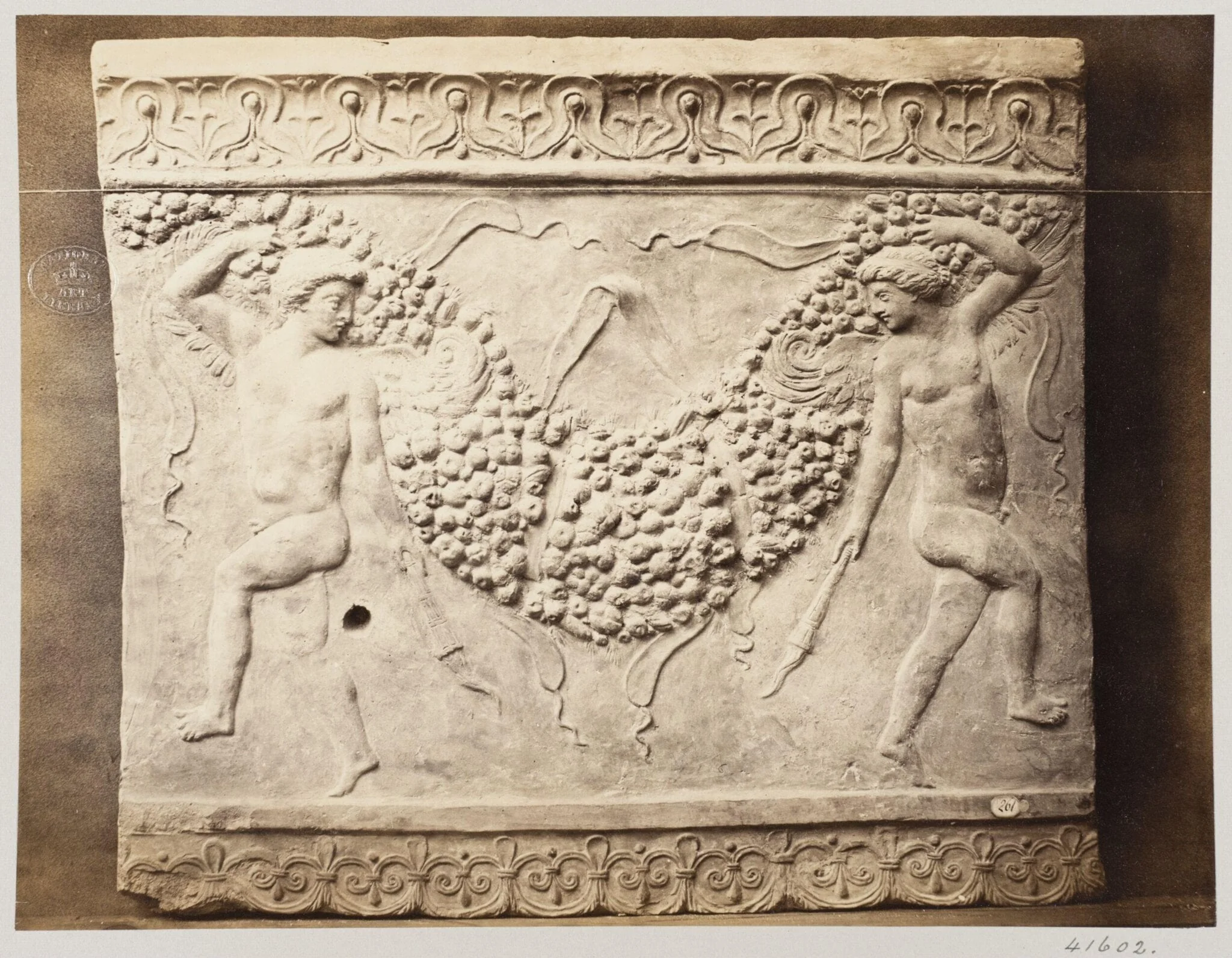 Bas-relief of portion of frieze of dancing figures with torches bearing festoon of fruit in terra cotta, detail