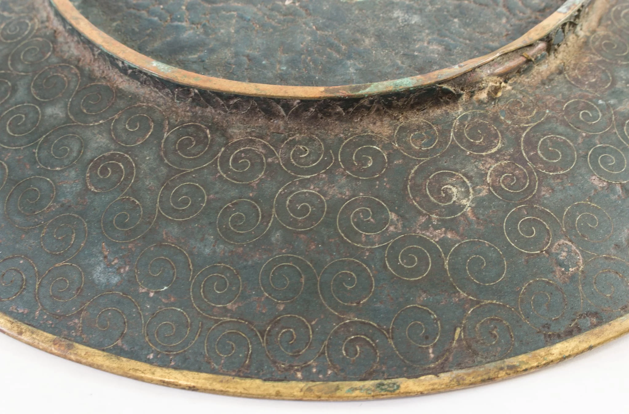 Piesă din metal pictat, incizat, de formă rotundă, puțin adâncită, cu fundul supraînălțat printr-un brâu circular. Decorul este dispus pe toată suprafața piesei, atât pe față (motive pictate: central, un buchet de crizanteme cu frunze, alături de fluturi; pe margine, un brâu circular cu motive de forma evantaiului), cât și pe spate (compoziție compactă de spirale incizate). Cromatică: albastru, verde, galben, negru, grena, roz, mov, violet, maro, alb., detail