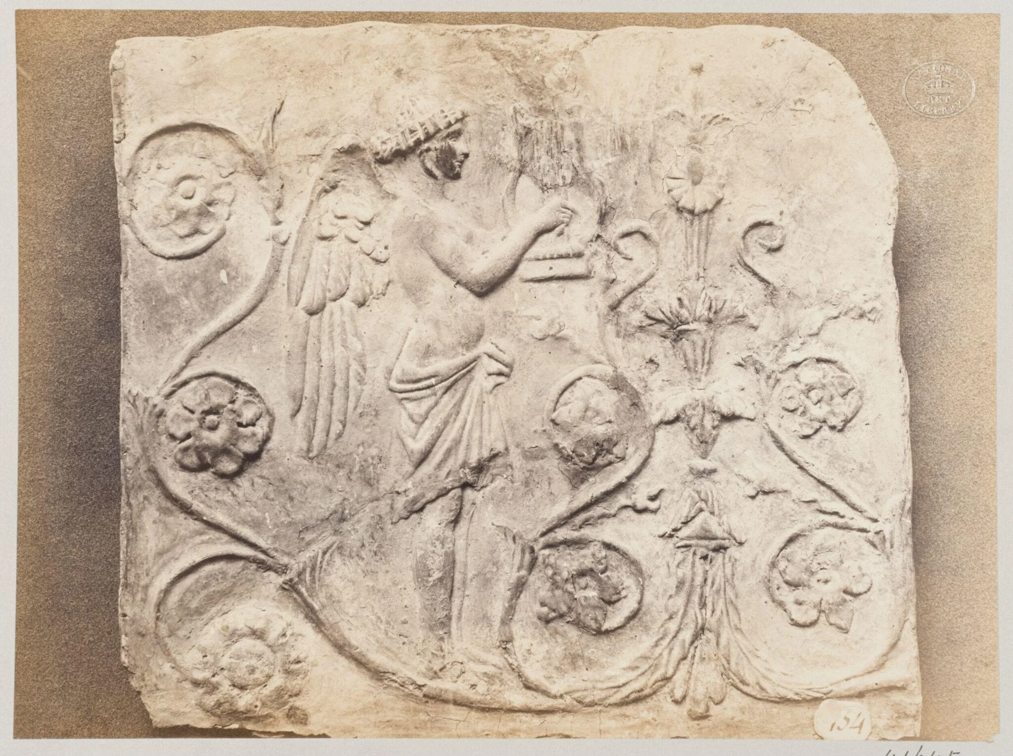 Bas-relief of a geni and a lyre in terra cotta, detail