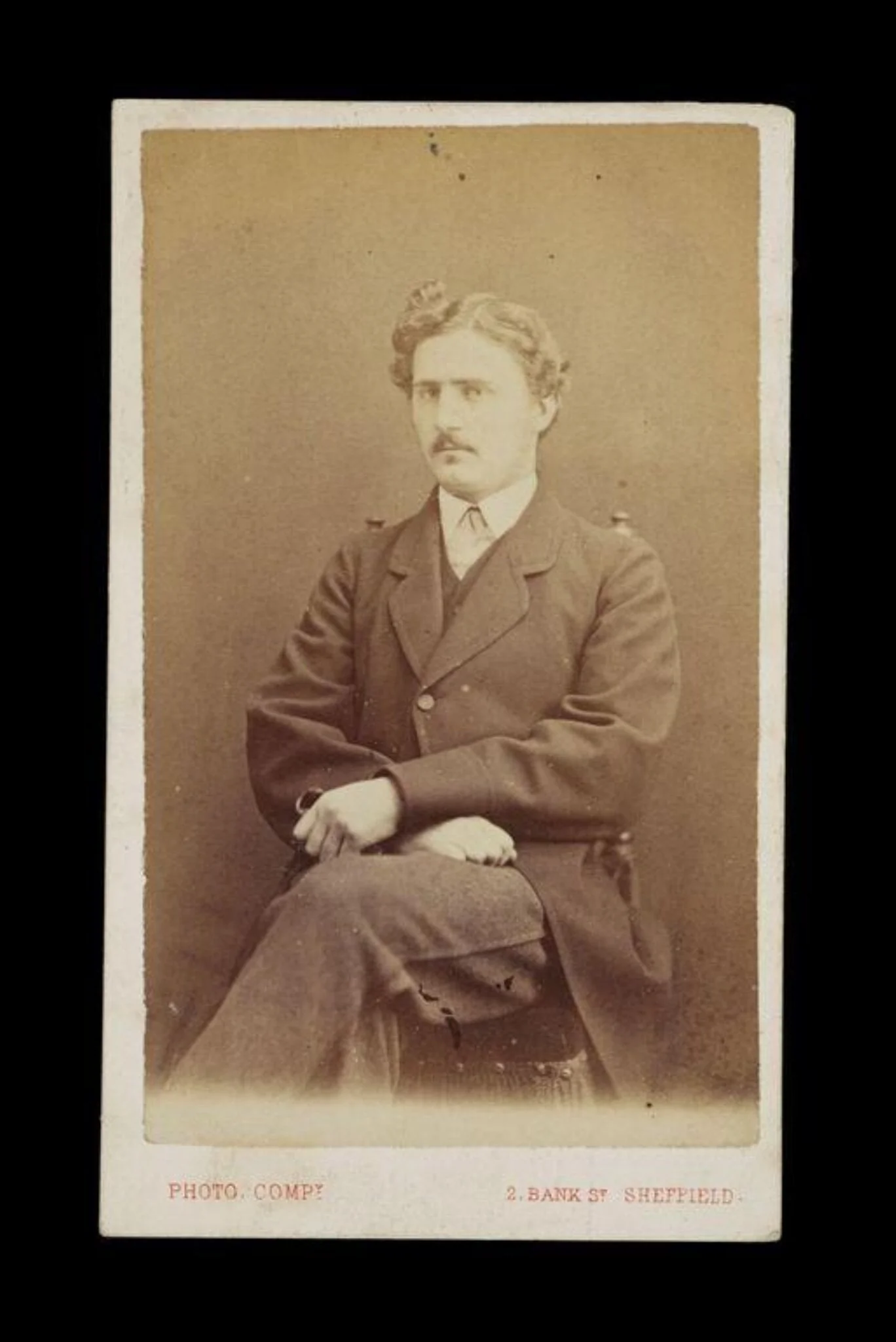 portrait of a man sat in a chair, detail