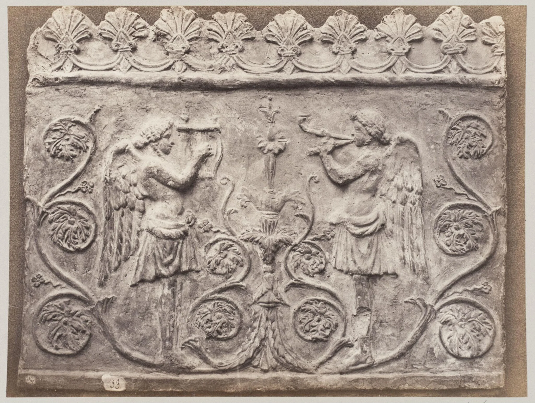 Bas-relief portion of frieze of Genii with double flutes and lyre, detail