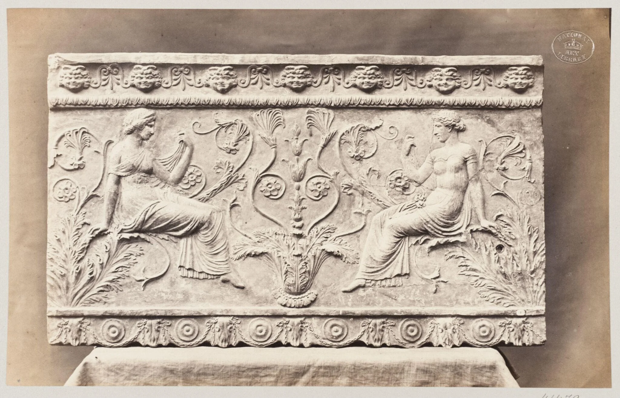 Two female figures seated on foliage ornament, bas-relief in terra cotta, detail