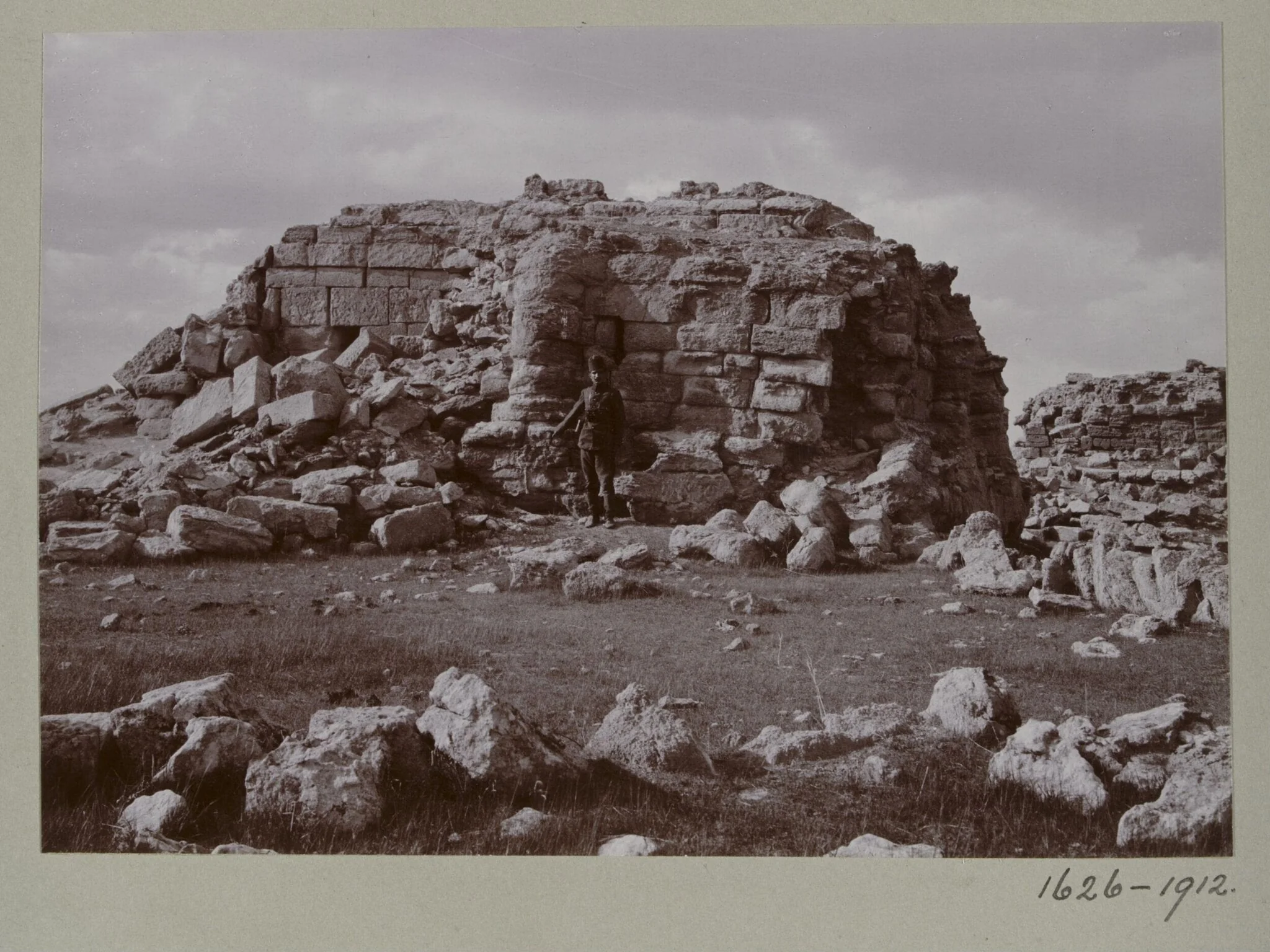 Photograph of a a ruined temple with a Turkish soldier in the Great Iwan at Hatra, Iraq, detail