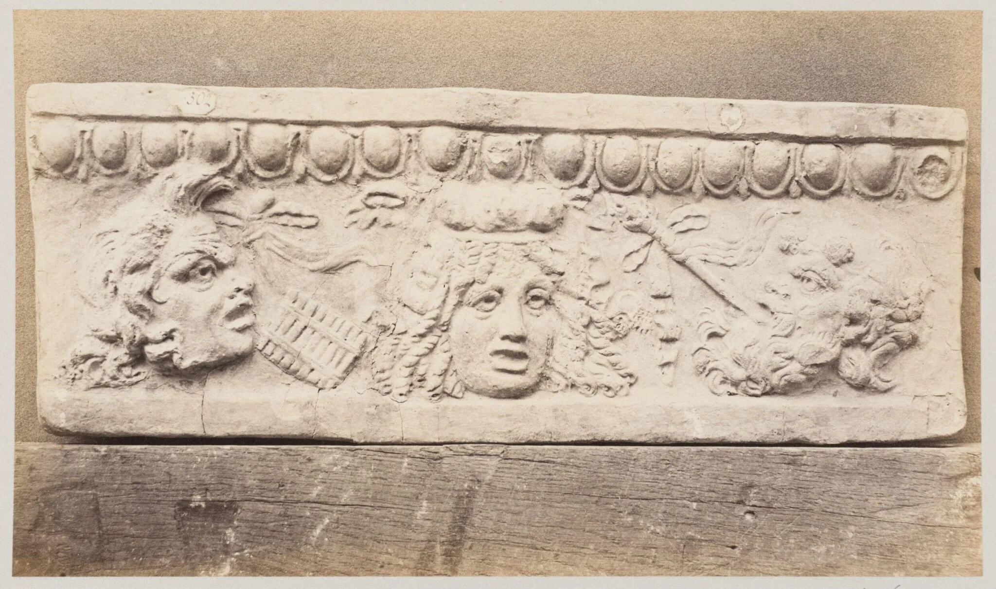 Bas-relief portion of frieze with theatrical masks in terra cotta, detail