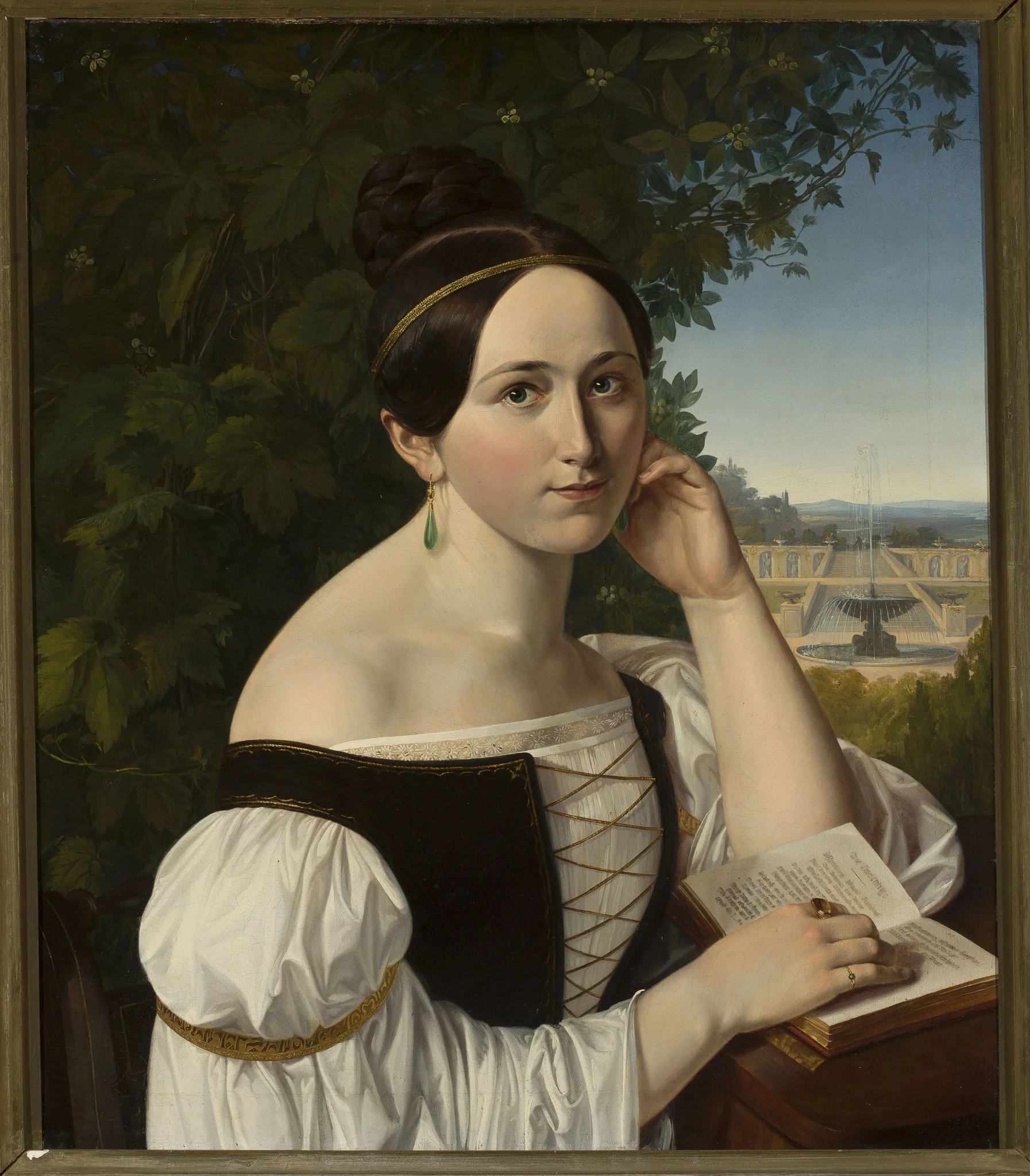 Portrait of a young woman with a book in a park, detail