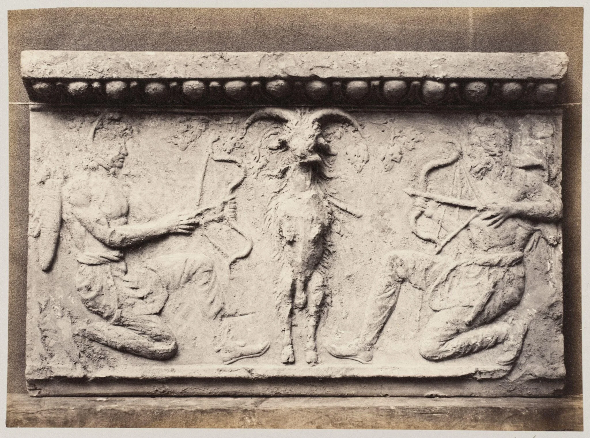 Bas-relief of a goat and two archers in terra cotta, detail
