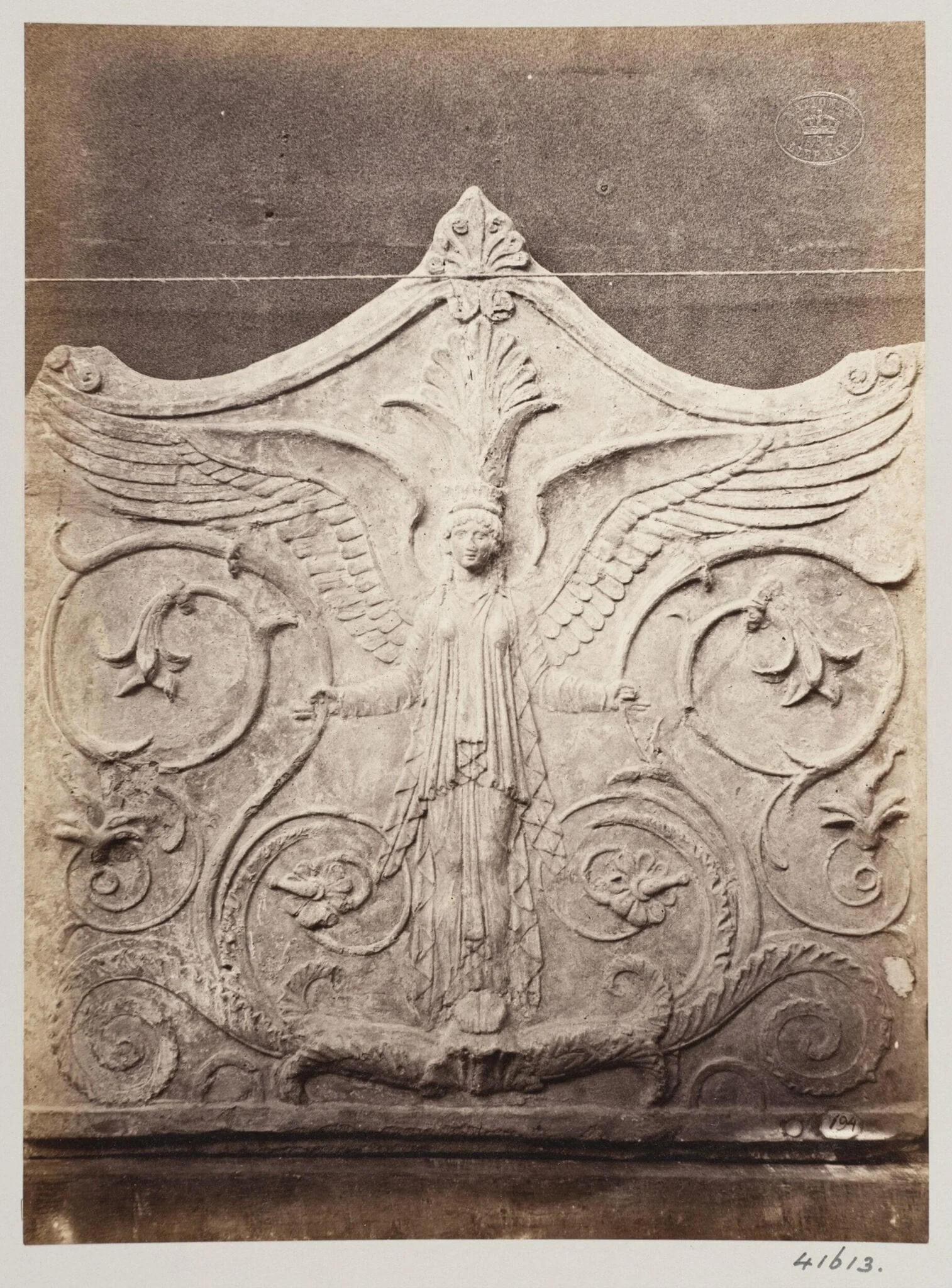 Bas-relief portion of a frieze of a winged figure with foliage in terra cotta, detail