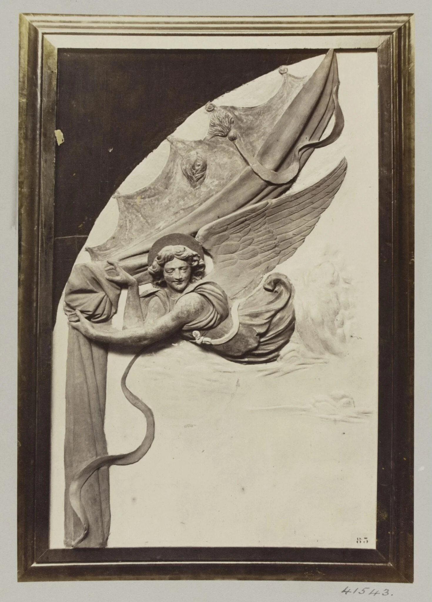 Bas-relief detail depicting an Angel drawing back a curtain in enamelled terra cotta and gilt, detail