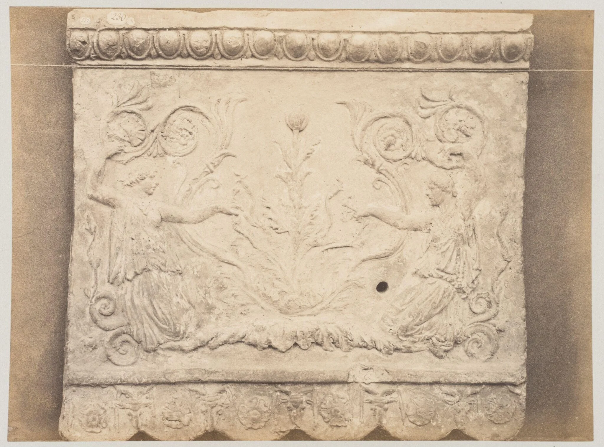 Bas-relief portion of frieze of nymphs with scrollwork in terra cotta, detail
