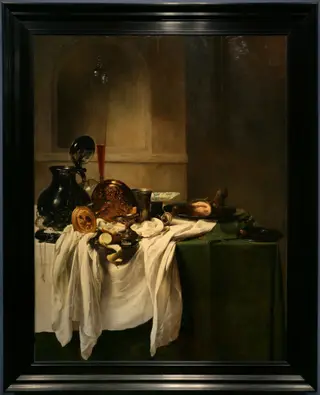 Still life of a laid table with ham and a view of a niche, by Jan Jansz den Uyl, paint, 1635