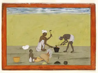 A blacksmith and his assistant