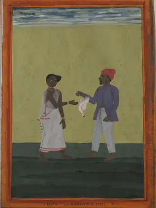 A cook holding a chicken