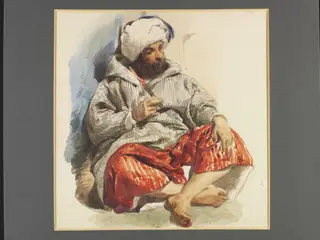 A European in Oriental dress, seated cross legged