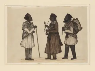 A Punjabi woman standing with a Punjabi man on either side.