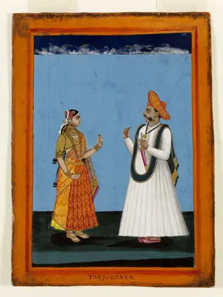 A Tanjore man in a white 'jama' holding 'pan' .