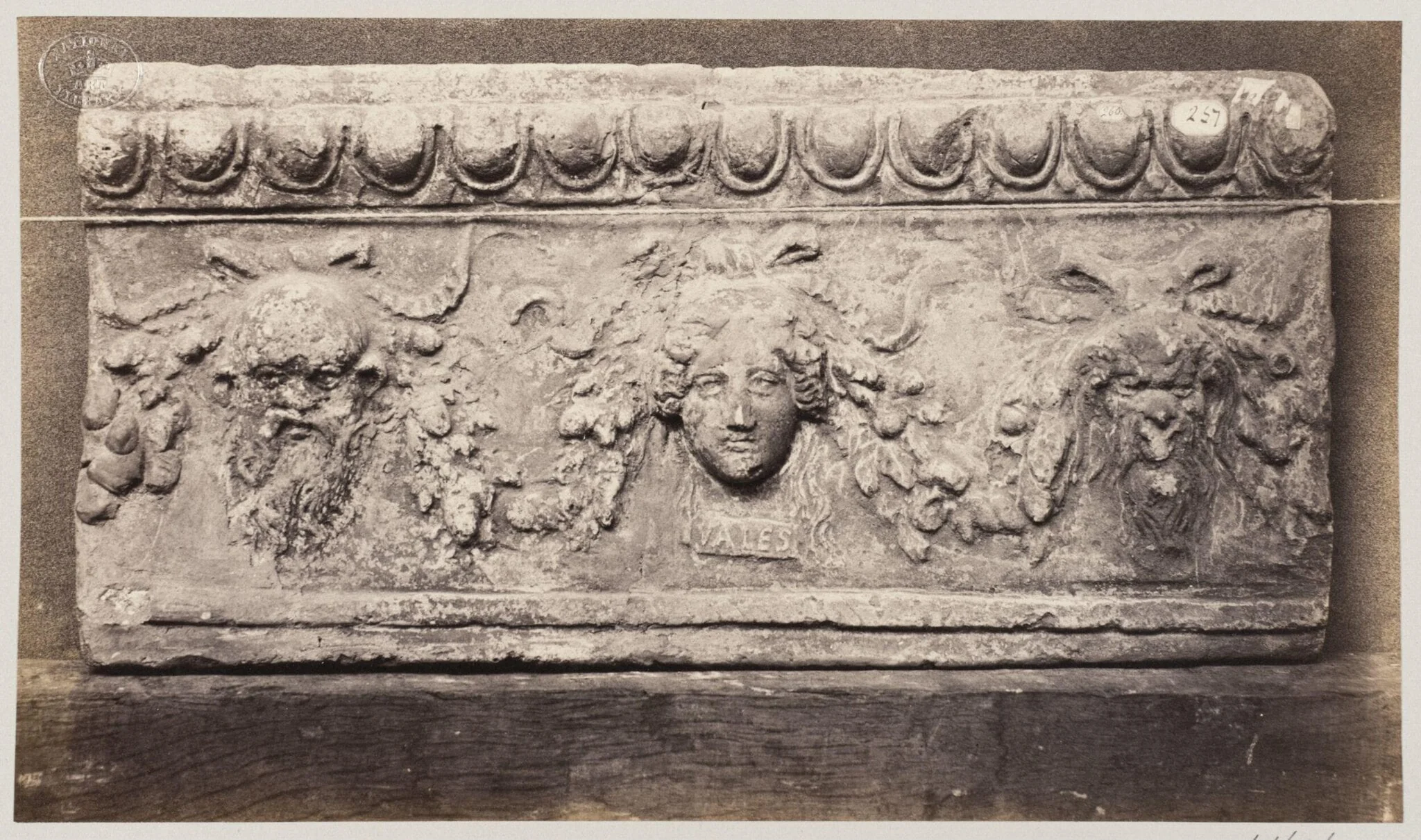 Bas-relief of three baccanalian masques in terra cotta, detail