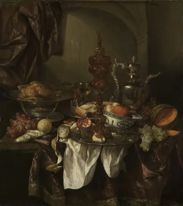 Still life with fruit, roast, silver- and glassware, porcelain and columbine cup on a dark tablecloth with white serviette