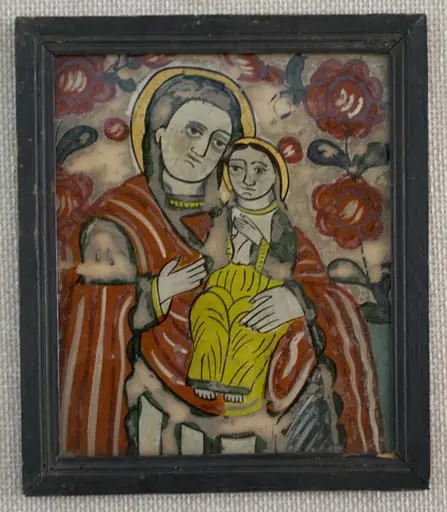 Icoana o reprezintă pe Maica Domnului cu Pruncul, tipul Hodighitria(Arătătoarea Căii). Cu mâna stângă susține Pruncul, cu dreapta arată către El. Maica are părul acoperit cu un văl verde.Veșmintele multicolore,(specific fazei de decadență a picturii de icoane pe sticlă)-roșu-mantia, cămașă, albă vrâstată cu verde, mâneci verzi, borduri diverse. Chipul cu umbre gri deschis, bărbia groasă, buze subțiri. Pruncul, cu amândouă mâinile la piept, are părul lung, castaniu și fața feminină. Aureolele sunt diforme, umplute cu bronz auriu. Câmp alb murdar decorat cu două ramuri cu flori roșii și boboci(ruje) care se unesc deasupra capului Maicii - 3/4 superior, bleu(1/4 inferior).Cromatica este dominată de roșu culorile stridente :alb, bleu, roșu, verde închis, ocru galben, brun, negru. Icoana are trăsăturile specifice picturii târzii din zona Nicula -Gherla: supraabundența detaliului, a decorului vegetal, apariția bronzului în locul foiței de aur, câmpul bicolor, sticla de proveniență industrială. Rama profilată este vopsită cu negru și încheiată oblic;dosul este din lemn subțire de brad;, by anonim