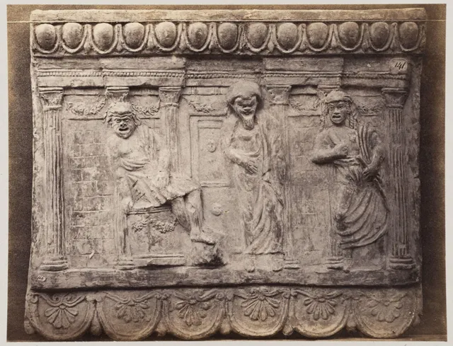 Bas-relief portion of frieze with three comic figures in terra cotta