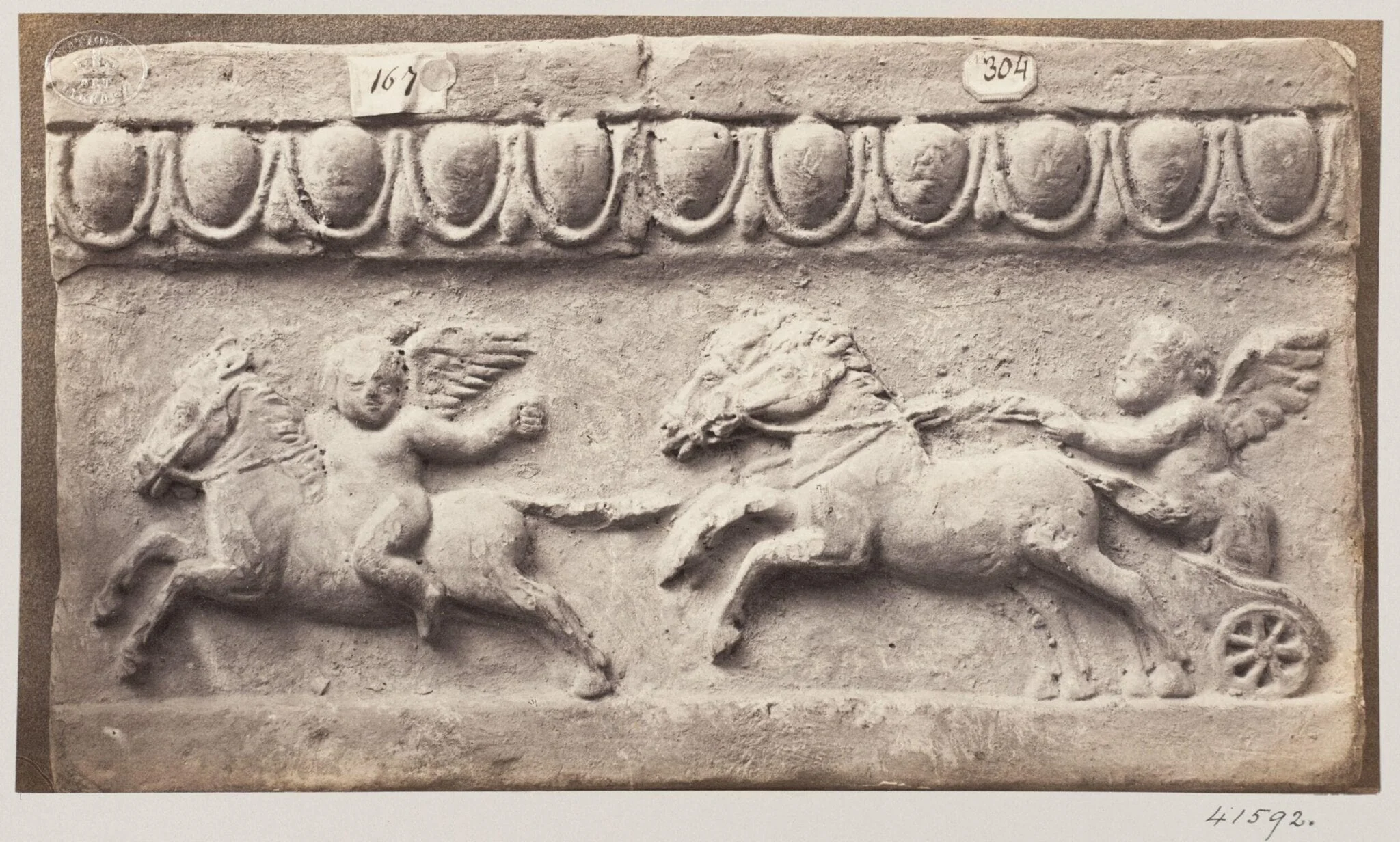 Bas-relief of a portion of a frieze in terra cotta depicting winged cupids and chariot and horses, detail