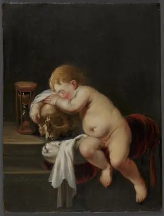 Boy sleeping on a Skull