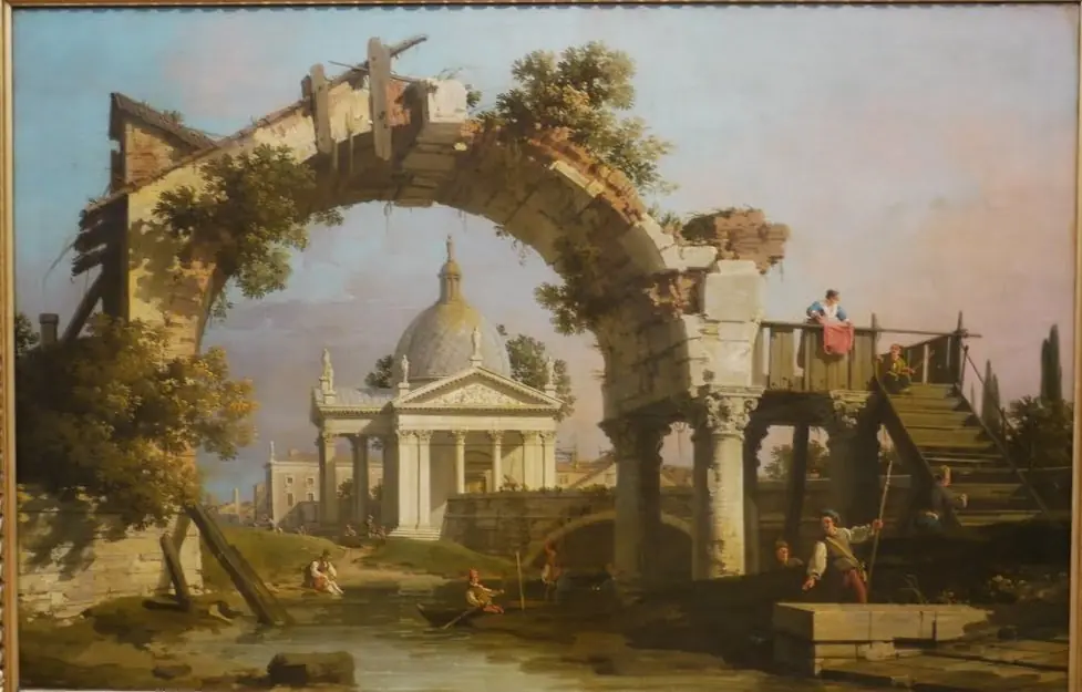 A Domed Church seen through a ruined Arch