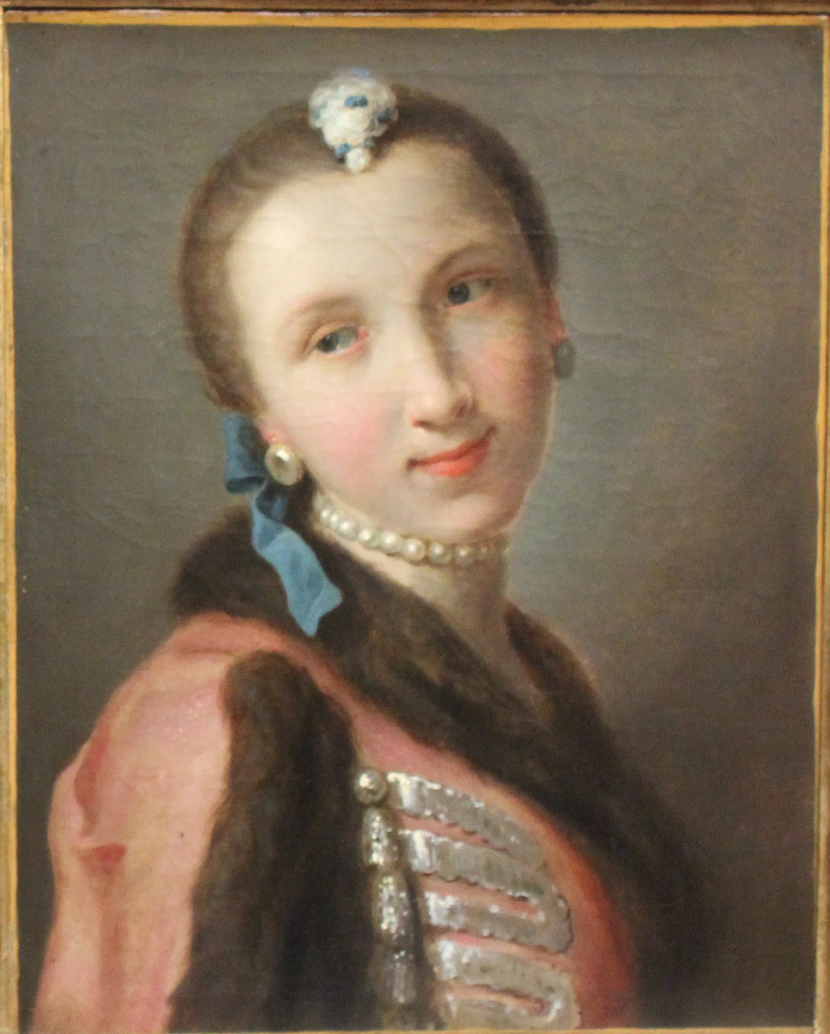 Smiling girl with pearl necklace, detail
