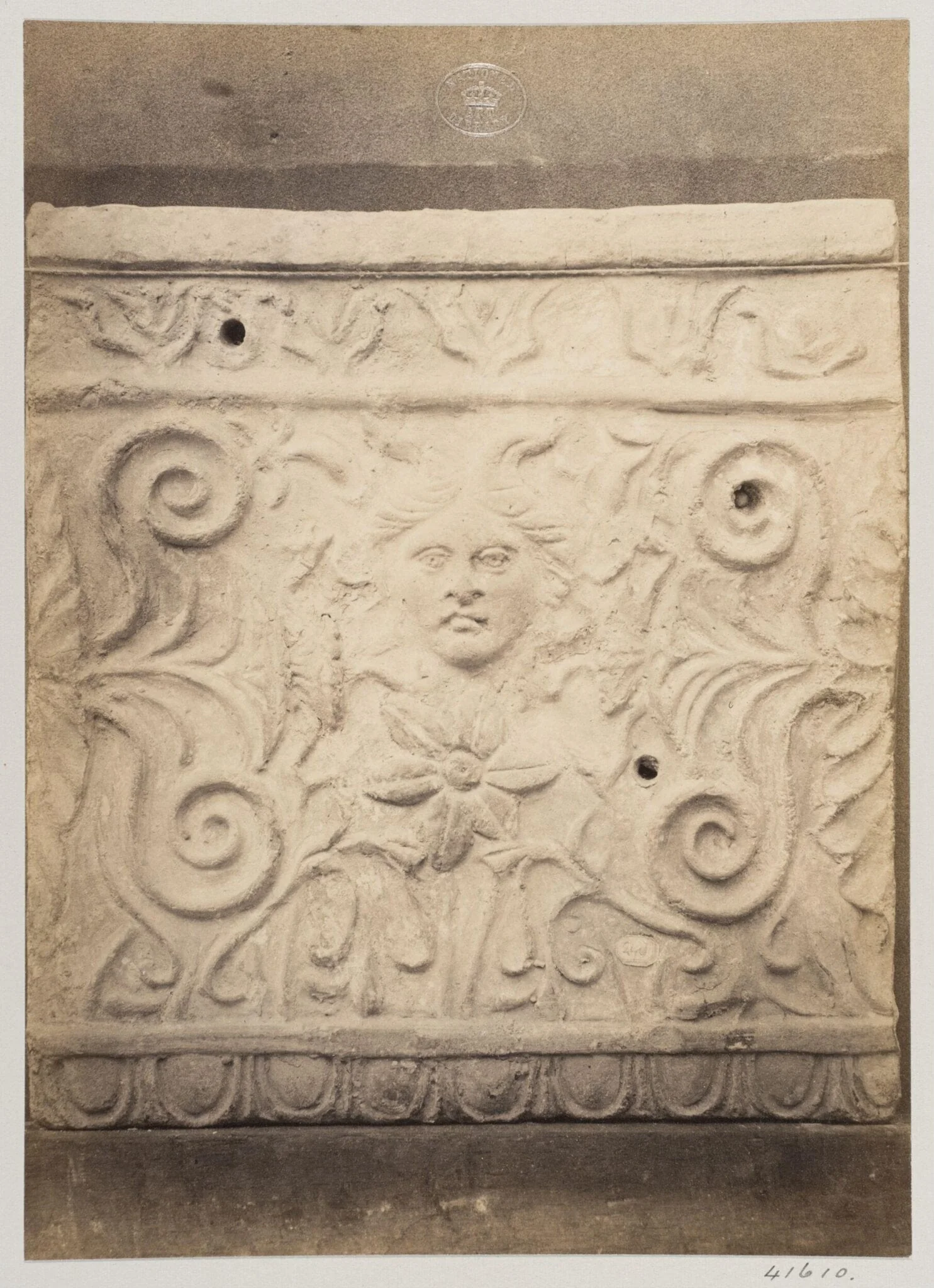 Bas-relief portion of a frieze with a mask in terra cotta, detail