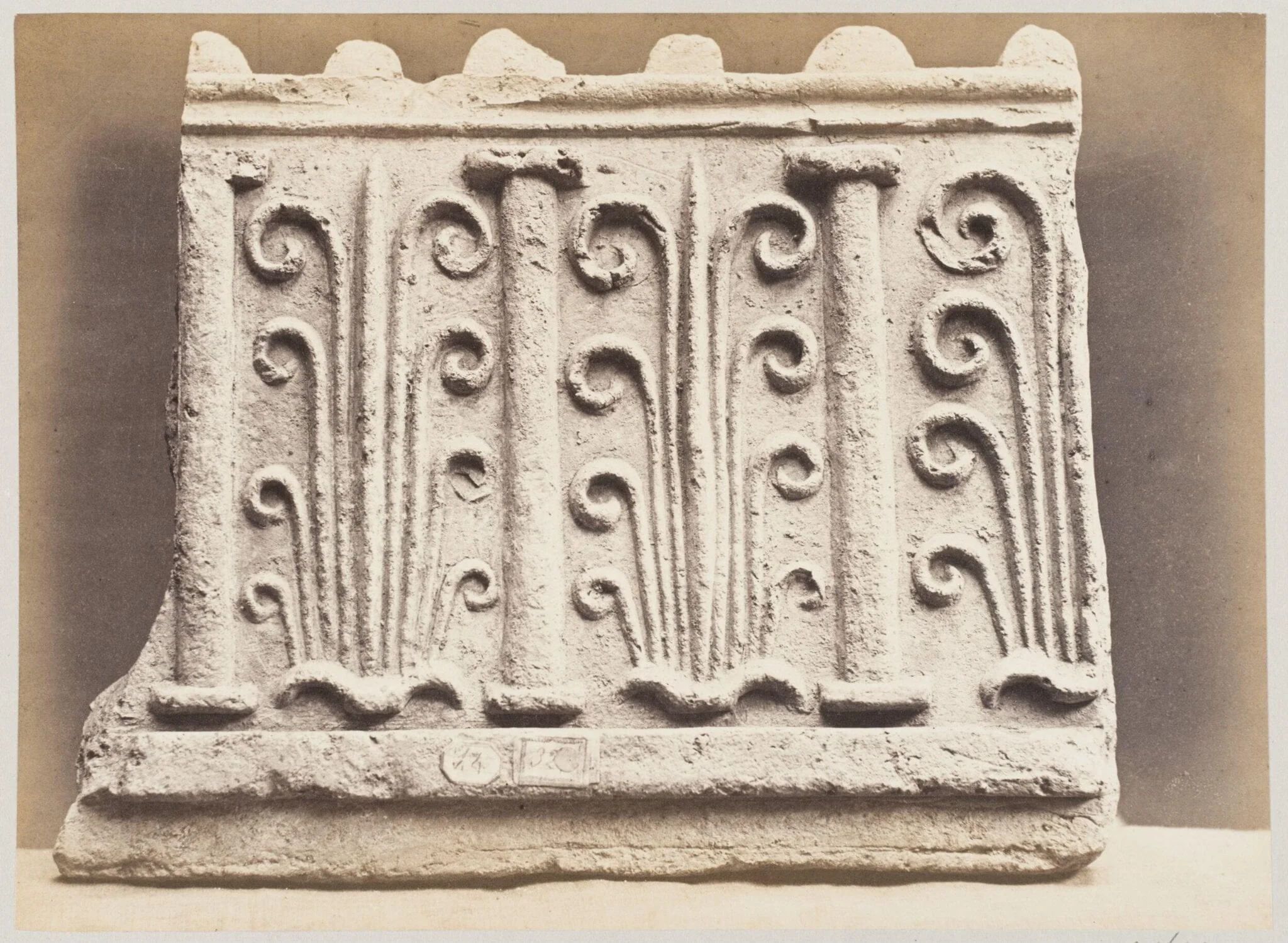 Bas-relief portion of frieze with palmettes and columns in terra cotta, detail