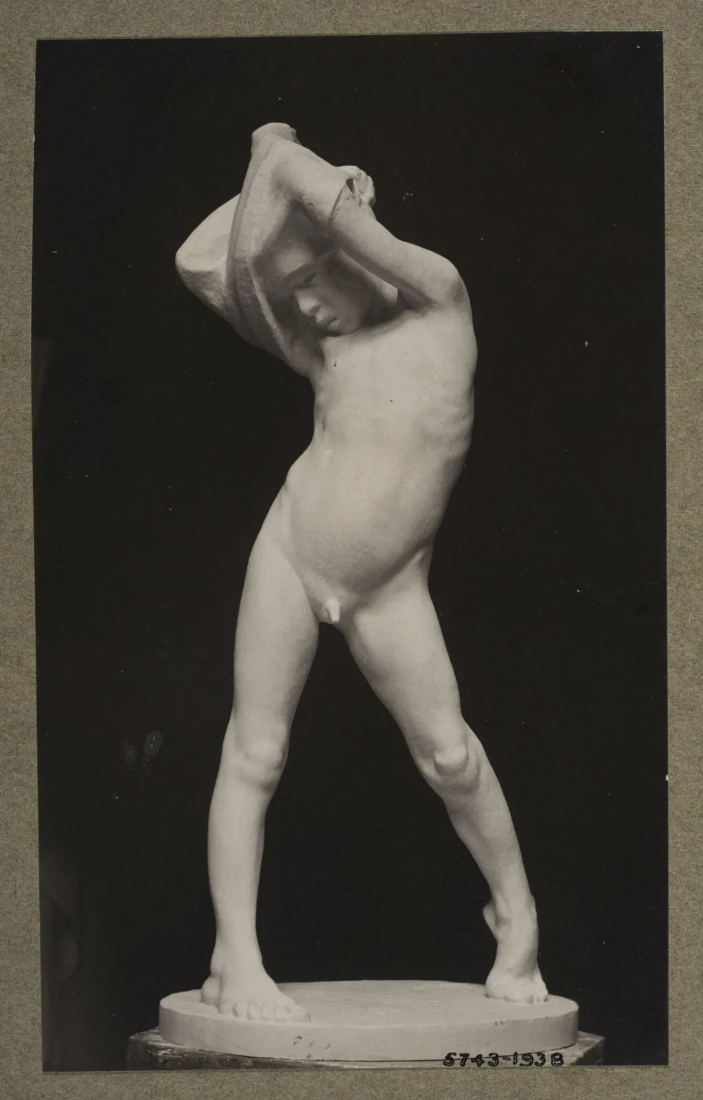 Boy struggling into his shirt, by Ercole Drei, photographic