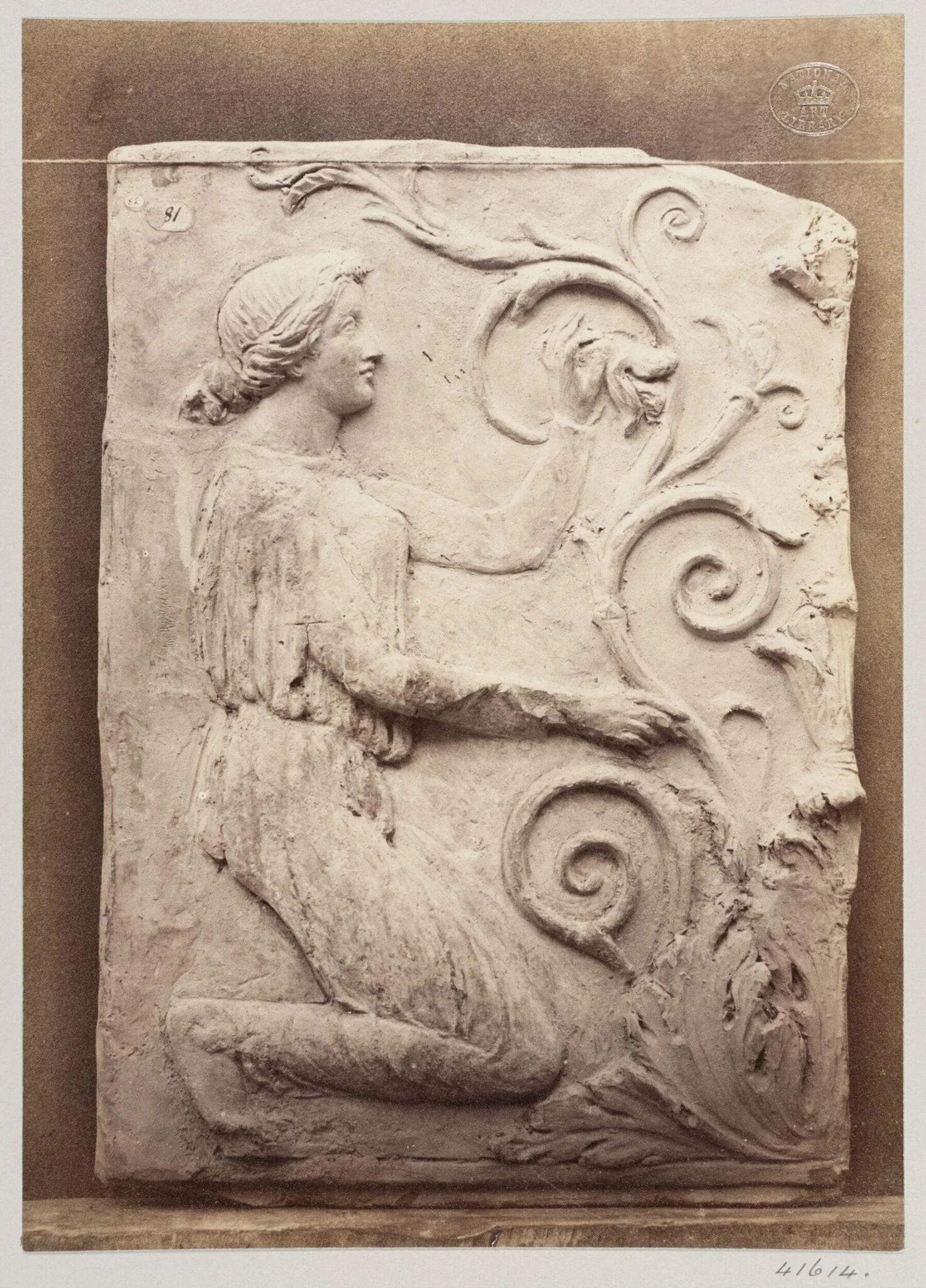Bas-relief portion of a frieze of a female figure and foliage in terra cotta, detail
