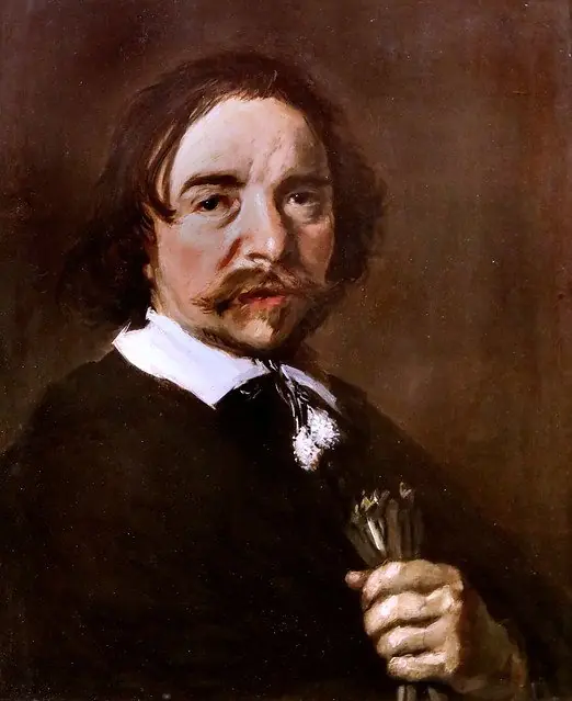 Portrait of a man with a tassle collar holding gloves or flax
