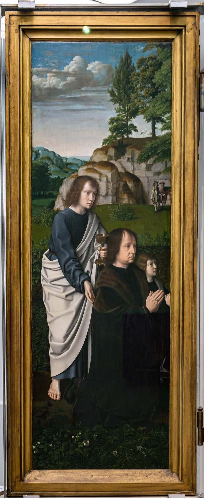 De H. Johannes de Evangelist met Jan de Trompes en zijn zoon, by Gerard David, oil, 1505