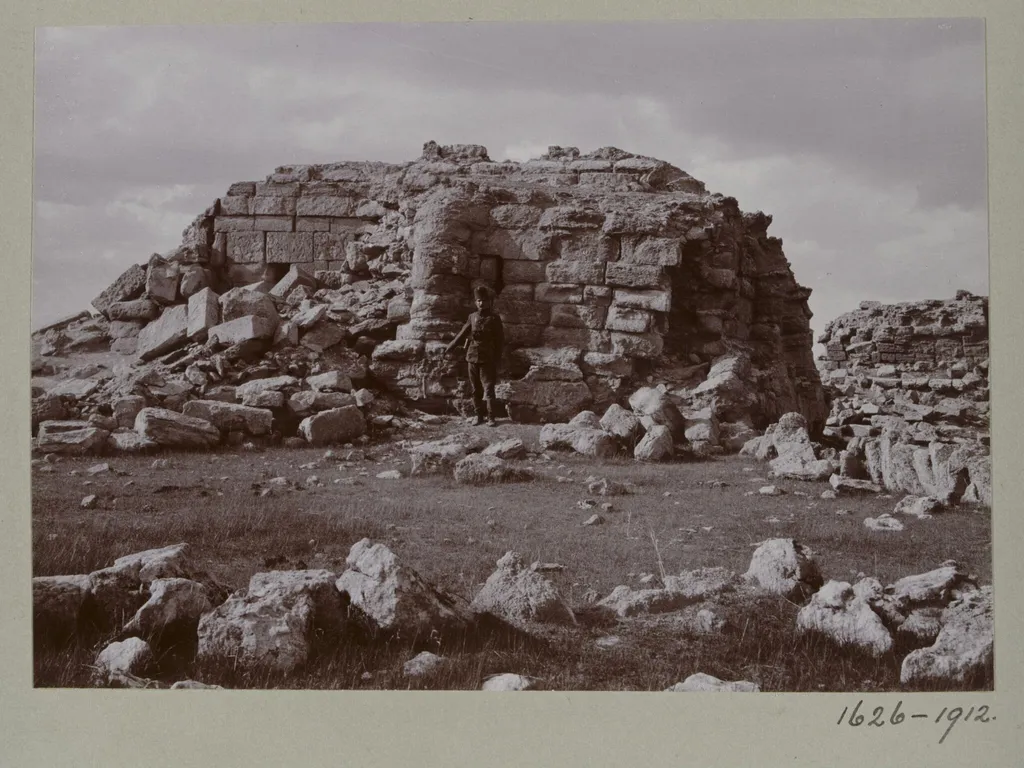 Photograph of a a ruined temple with a Turkish soldier in the Great Iwan at Hatra, Iraq, by Gertrude Margaret Lowthian Bell, photographic, 1911