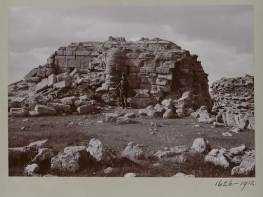 Photograph of a a ruined temple with a Turkish soldier in the Great Iwan at Hatra, Iraq, by Gertrude Margaret Lowthian Bell