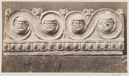 Bas-relief scroll with four masques in terra cotta, by Louise Laffon