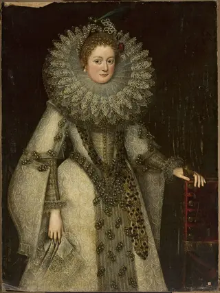 Portrait of a lady in a rich costume leaning on the armchair