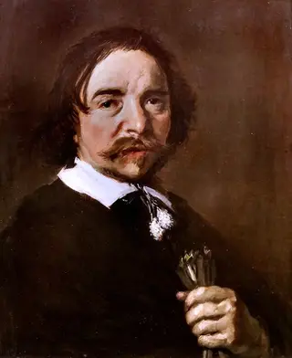Portrait of a man with a tassle collar holding gloves or flax