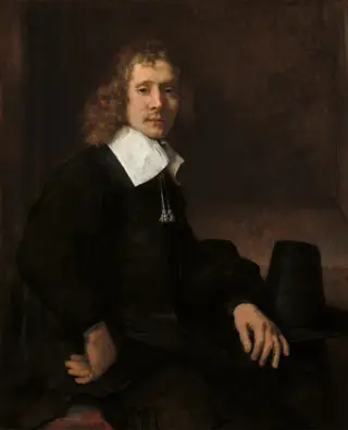 A Young Man Seated at a Table (possibly Govaert Flinck), by Rembrandt van Rijn, 1660