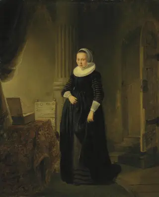 Portrait of a woman, standing full length in an interior, by Rembrandt van Rijn
