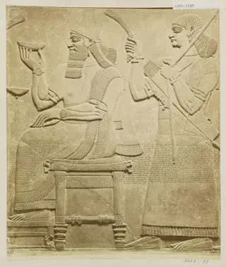 Sculpture, relief of figure seated with attendant. London: British Museum