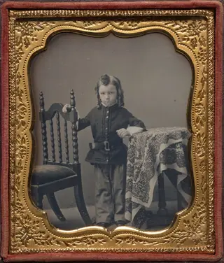 Standing boy with bottle curls