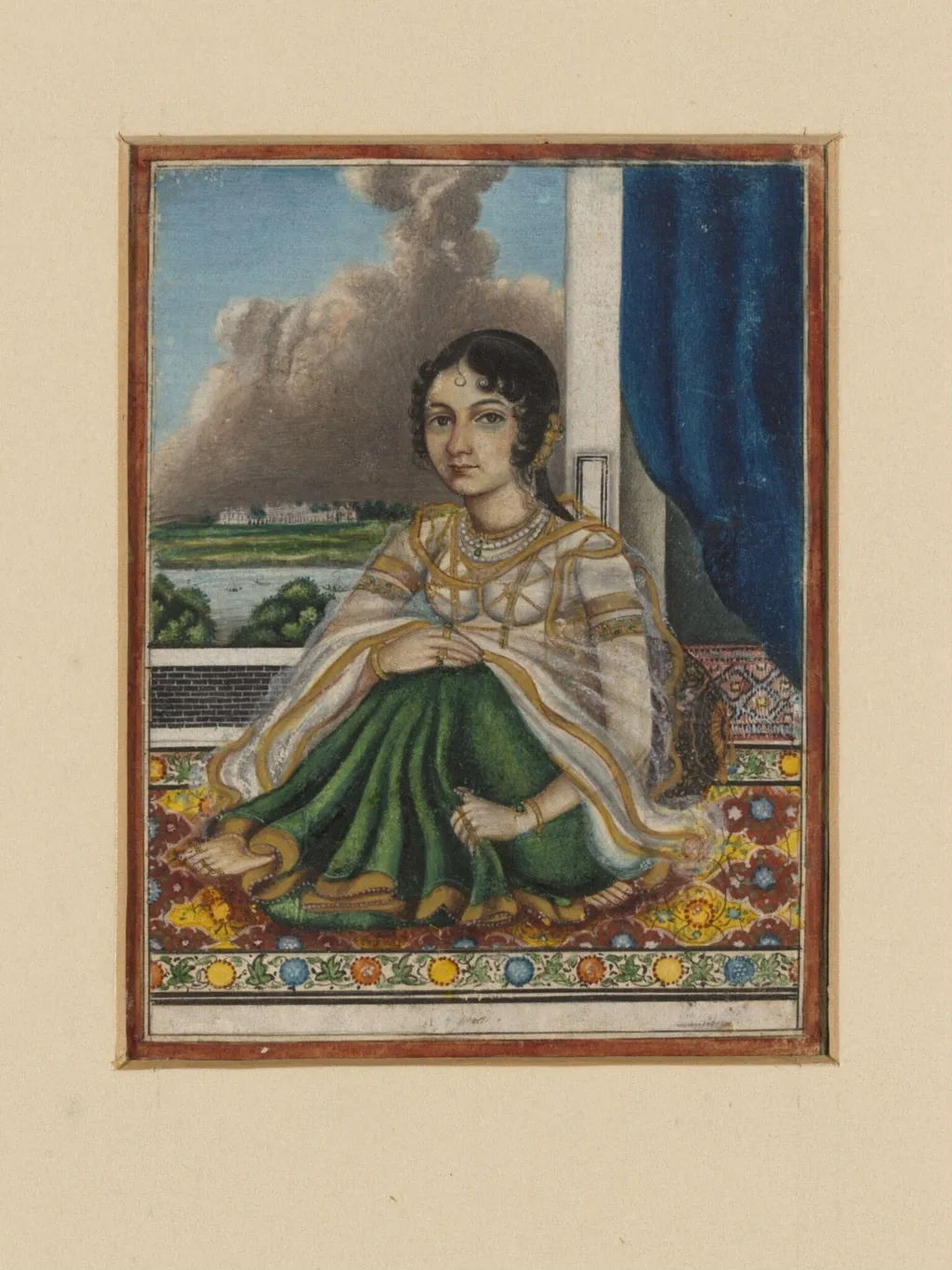 An Indian lady seated on a carpet by an open door overlooking a river with a European-style house on the opposite bank., by Unknown, paint, 1850