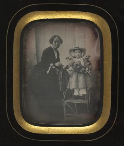 Child Standing on a Chair Holding Flowers, with Mother, by Unknown