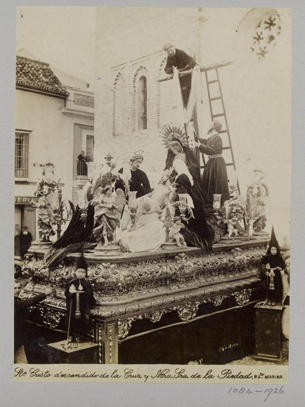 Processional statuary group belonging to the Fraternity of the Parish of Santa Marina, Seville, with children in special dress in the foreground, by Unknown, photographic, 1850