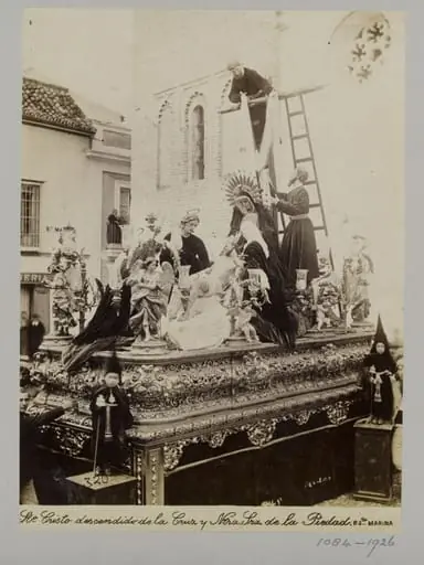 Processional statuary group belonging to the Fraternity of the Parish of Santa Marina, Seville, with children in special dress in the foreground, by Unknown