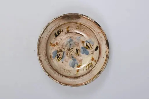 Vas de formă tronconică adâncit, smălțuit în interior. Este decorat pe margine cu motive geometrice: cercuri concentrice, iar în centru cu motive vegetale și florale. Decorul este realziat prin pictare. Cromatică: fond cărămiziu (exterior); fond alb (interior); albastru; maro; portocaliu., by Unknown