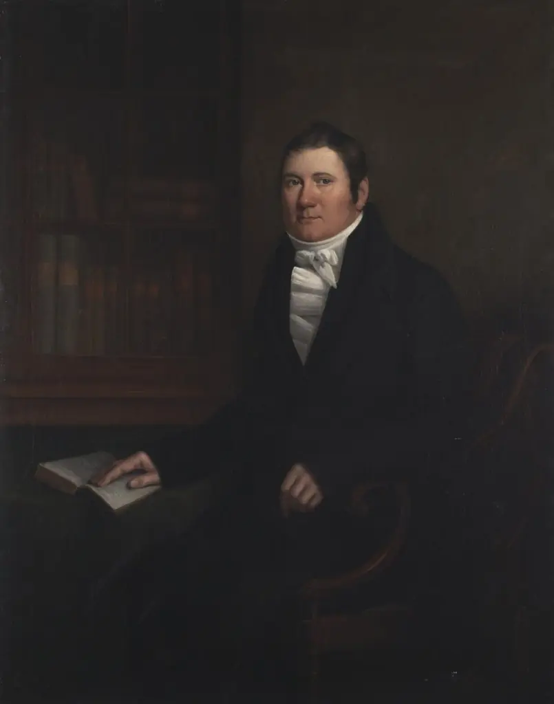 Man sitting at a table with an open book, by William Shiels